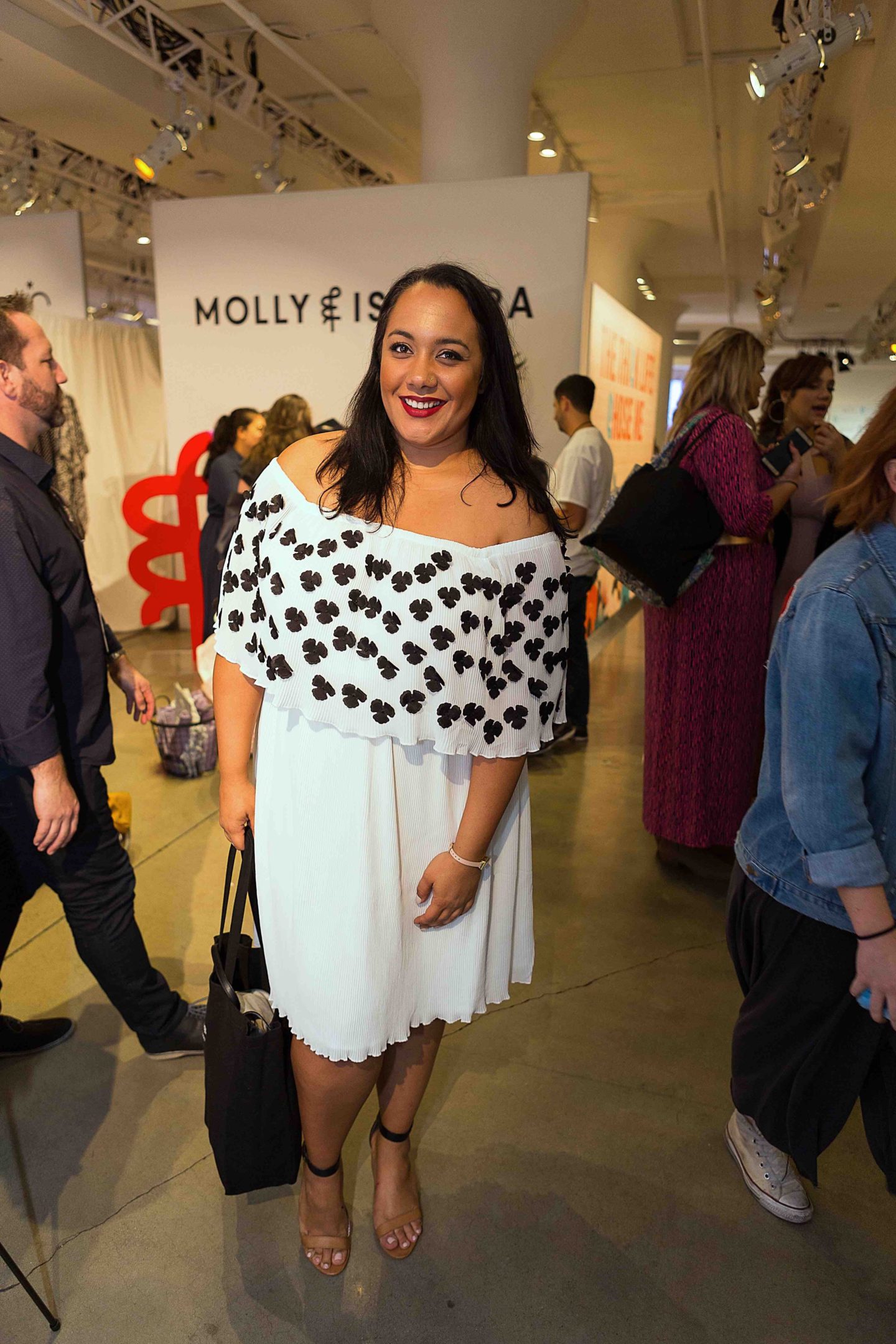 Amy Stretten, the Chief of Style, at the CurvyCon wearing an off the shoulder dress by Eloquii.
