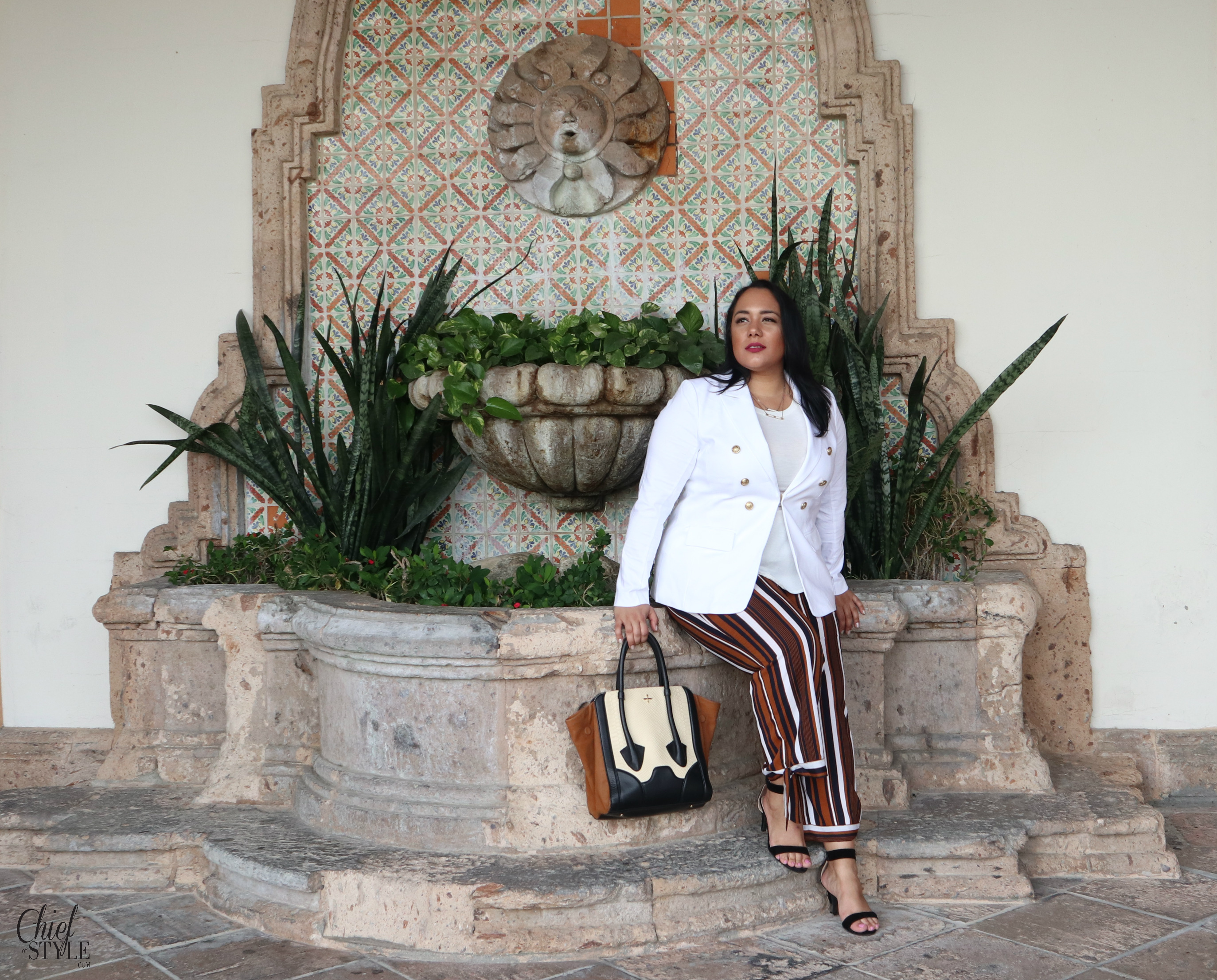 Amy Stretten Chief of Style in Palm Springs, California wearing plus size clothing by Lane Bryant blazer and Fashion Nova Pants with a Pour La Victoire tote bag